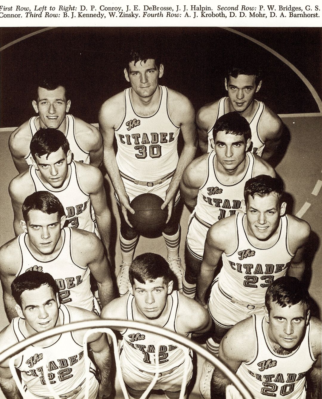 "It was my fourth year at The Citadel and the fourth time October 15 had marked the beginning of basketball practice. Mel Thompson was famous for working his team hard on the first day and traditionally ran us so much that the first practice was topped off by one of us vomiting on the hardwood floor.
I made my way to the locker room early that afternoon because I wanted some time to myself to shoot around and think about what I wanted to accomplish this season. Four of my teammates were already dressed when I entered the dressing room door. The room carried the acrid fragrance of the past three seasons for me, an elixir of pure maleness with the stale smell of sweat predominant yet blended with the sharp, stinging unguents we spread on sore knees and shoulders, Right Guard deodorant spray, vats of foot powder to ward off athlete's foot, and deodorant cakes in the urinals. It was the powerful eau de cologne of the locker room. I realized that my life as a college athlete was coming to its inevitable end, but I did not know that you had to leave the fabulous odors of youth behind when you hurried out into open fields to begin life as an adult.
As I entered the room, I waved to Al Beiner, the equipment manager. He and his assistant Joe 'Rat' Eubanks were making sure that the basketballs were all inflated properly. Carl Peterson, another assistant, had just returned with a cartful of freshly laundered towels, still warm to the touch.
'The Big Day,' Al said. He was reserved and serious and considered the players juvenile and frivolous. Al's presence was priestlike, efficient.
'Senior year,' Rat said. 'It all comes together for the big guy this year, right, Pat?'"
~from My Losing Season, Pat Conroy, '67