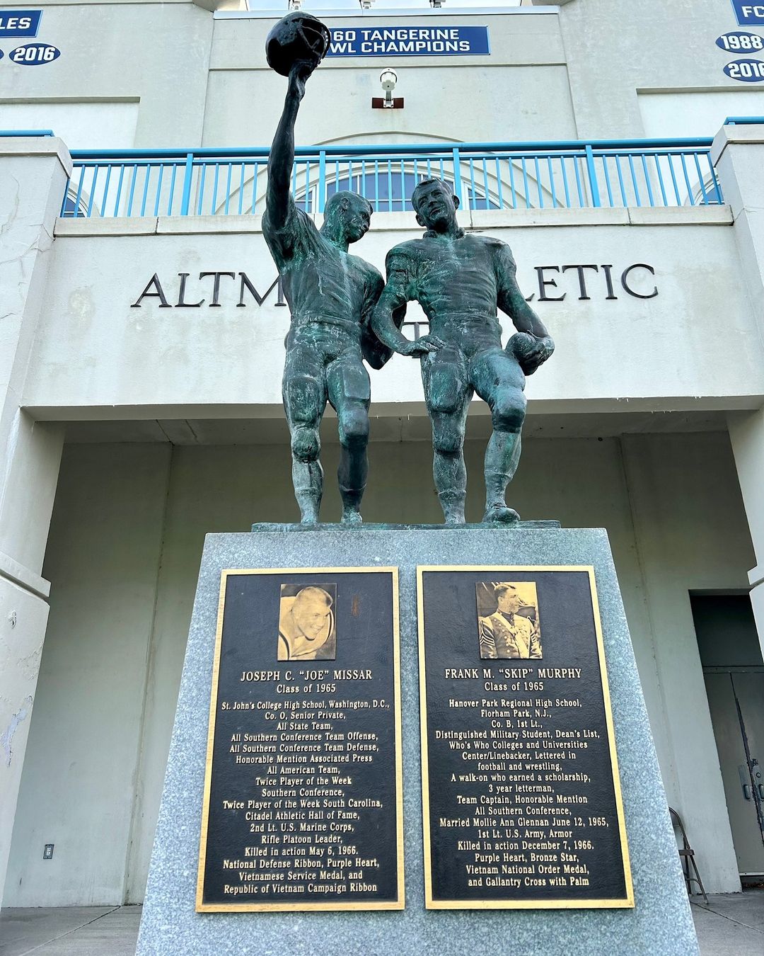 1LT Frank Monroe (Skip) Murphy, USA, '65, was killed in action on December 7, 1966, in South Vietnam by a land mine while rescuing members of his platoon who were in a firefight after being jumped from behind by the Vietcong. Murphy is memorialized along with 2ndLt Joseph C. Missar, USMC, '65, with a bronze statue, located in Johnson Hagood Stadium, in the photograph here. Missar was killed in action by a mine in the Quan Nam Province of Vietnam on May 6, 1966. The statue honors all Citadel Alumni who died in the Vietnam War.