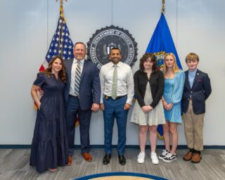 William L. Epkins, ’98, retired from the FBI after serving as a special agent for 22 years, working on violent crimes in D.C. and a gang task force in Baltimore. He also served on SWAT teams for approximately 10 years and was an FBI firearms instructor for 18 years. Epkins is pictured here with his wife, Lindsay, his family and FBI Director Kash Patel.