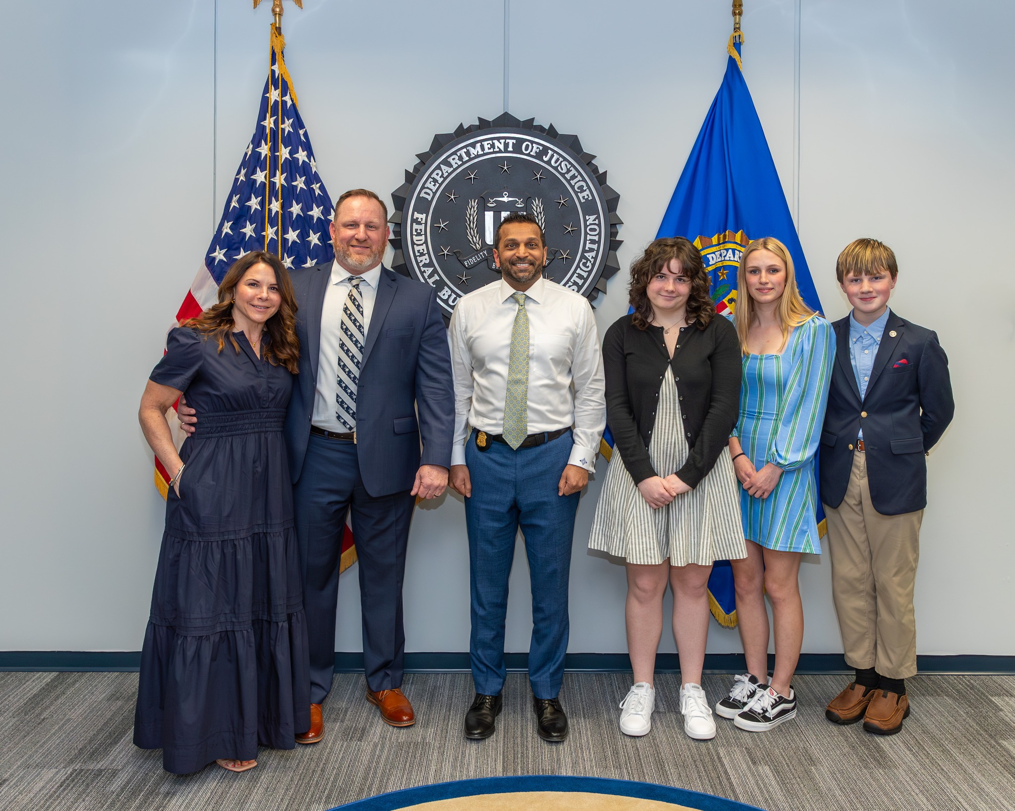 William L. Epkins, ’98, retired from the FBI after serving as a special agent for 22 years, working on violent crimes in D.C. and a gang task force in Baltimore. He also served on SWAT teams for approximately 10 years and was an FBI firearms instructor for 18 years. Epkins is pictured here with his wife, Lindsay, his family and FBI Director Kash Patel.